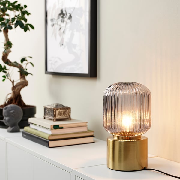 SOLKLINT table lamp, brass/grey clear glass, 28 cm