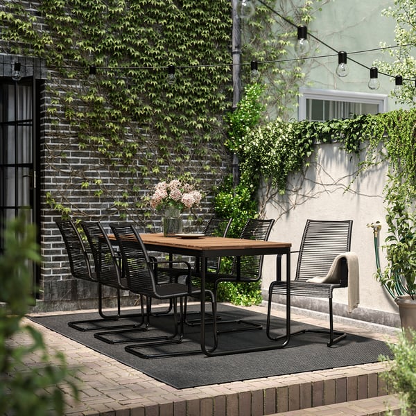 VÄSMAN / VÄSMAN table+6 chairs w armrests, outdoor, extendable light brown stained/black, 135x190/74 cm