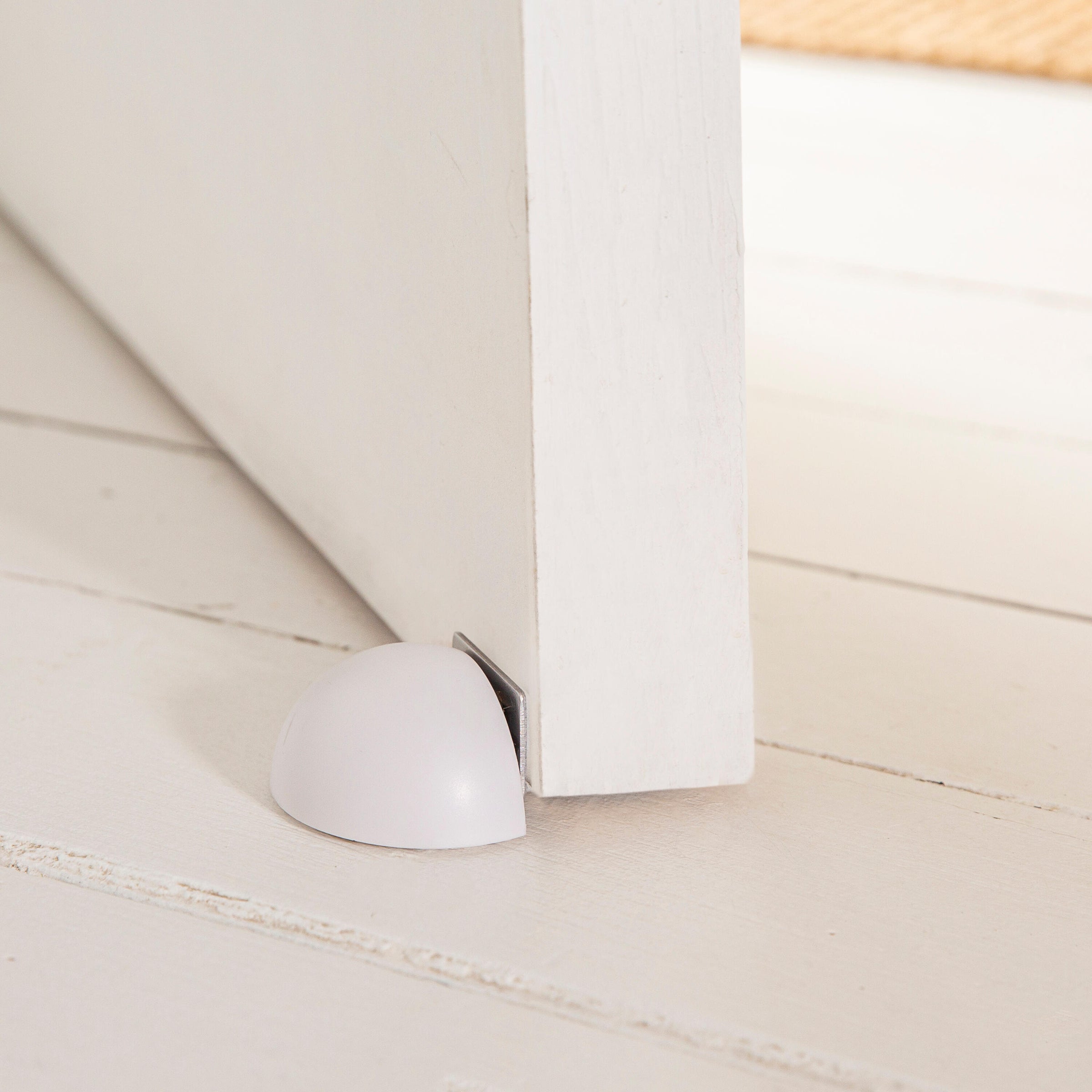 MAGNETIC DOORSTOP WITH ADHESIVE FASTENER