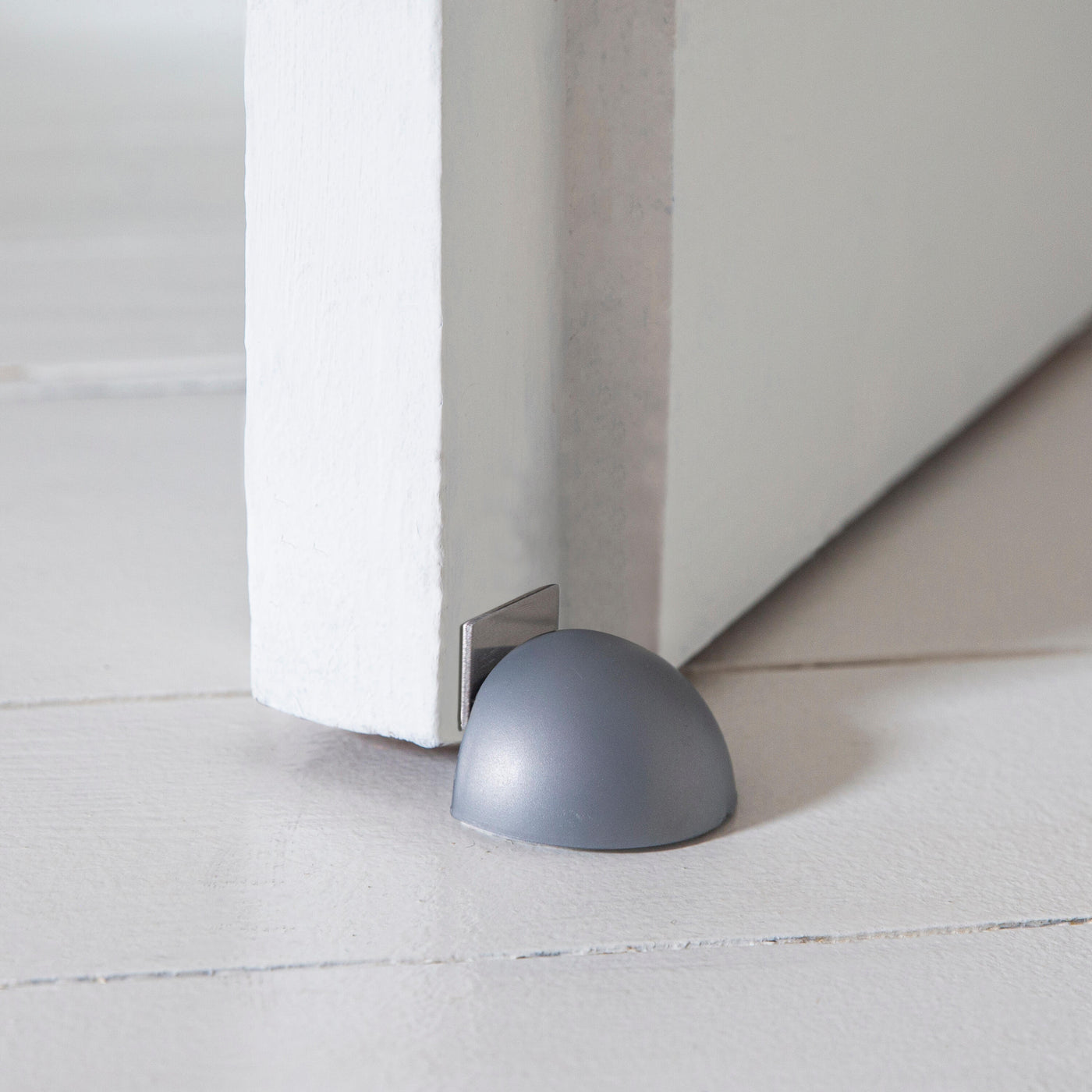 MAGNETIC DOORSTOP WITH ADHESIVE FASTENER