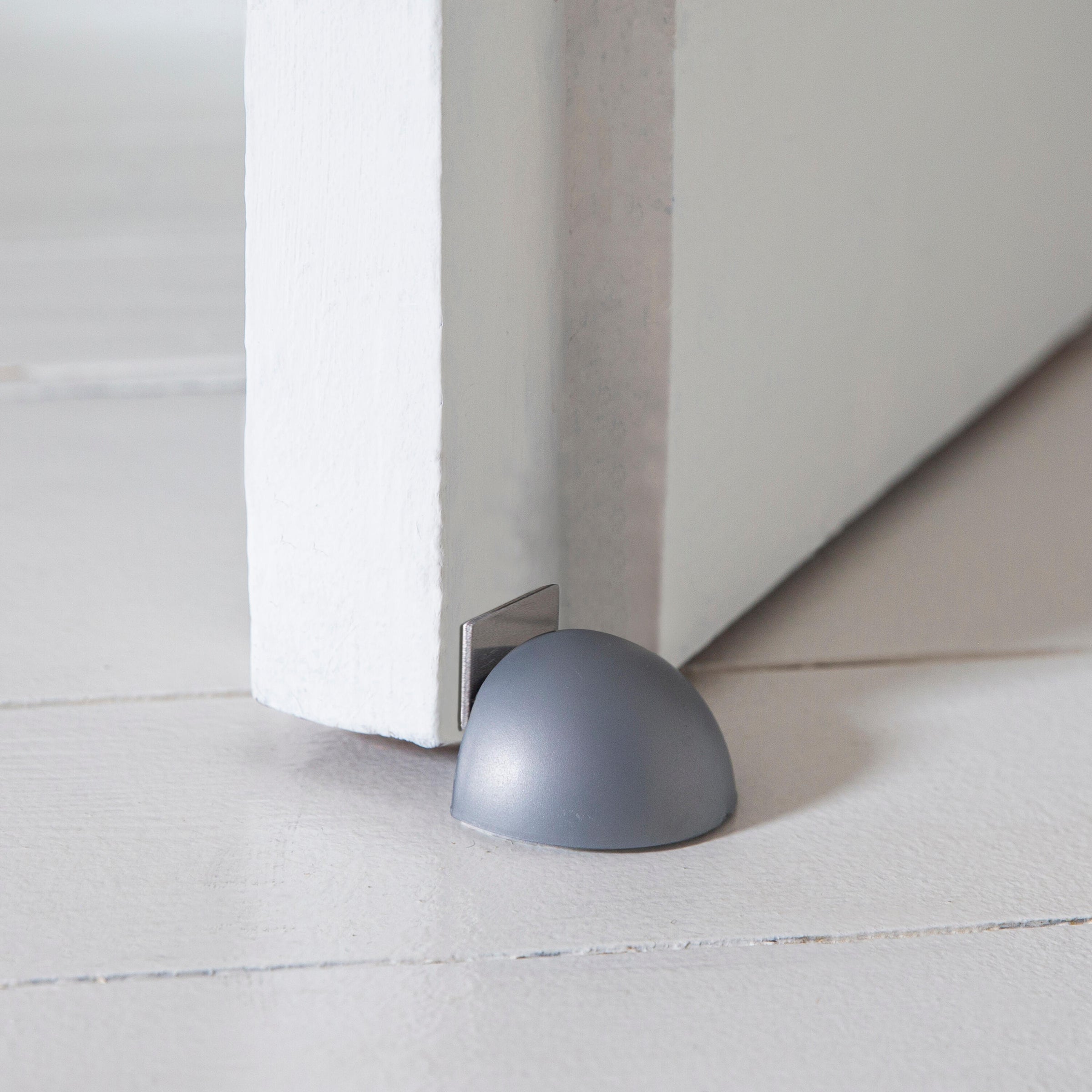 MAGNETIC DOORSTOP WITH ADHESIVE FASTENER