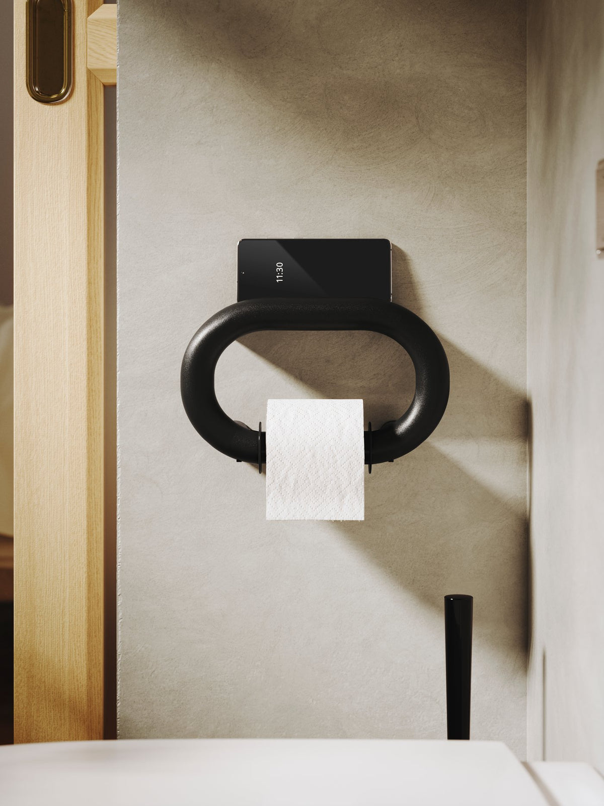 A bathroom with natural tones and dark contrasts