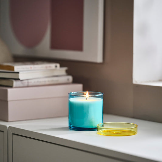 DVÄRGHÖK scented candle in glass with lid, Fig leaf blue/light yellow, 50 hr