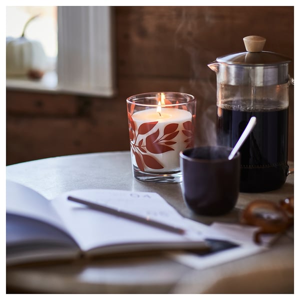 HÖSTAGILLE scented glass candle, Vanilla and apple clear/orange glass, 50 h - IKEA United Kingdom