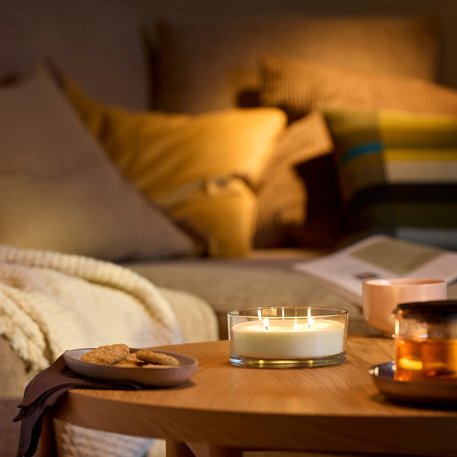 LOTSFÅGEL scented candle in glass, 3 wicks, Vanilla pale beige, 15 cm