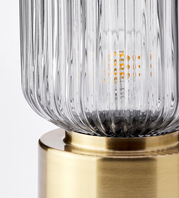 SOLKLINT table lamp, brass/grey clear glass, 28 cm