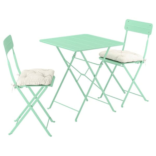 SUNDSÖ table and 2 folding chairs, outdoor light green/light green Kuddarna light grey-beige, 65x65 cm