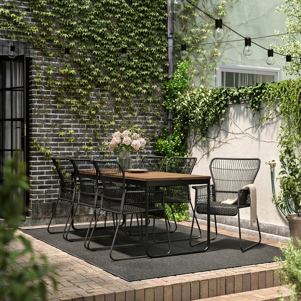 VÄSMAN / TALLSKÄR table+6 chairs w armrests, outdoor, extendable light brown stained/anthracite, 135x190/74 cm
